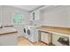 A tidy laundry room is equipped with a washer, dryer, sink, and counter space at 108 E Walker Dr, Summerville, SC 29483