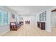 Bright living room with wood floors, a bench seat, and a view into the dining room at 108 E Walker Dr, Summerville, SC 29483