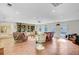 Expansive living room with a projector, built-in shelving, and lots of natural light from several windows at 108 E Walker Dr, Summerville, SC 29483
