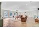 Large living room with natural light, comfortable seating, projector, and durable flooring at 108 E Walker Dr, Summerville, SC 29483