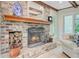 Living room with brick fireplace, wood mantle, and hardwood floors at 108 E Walker Dr, Summerville, SC 29483