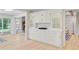 Living room with white cabinets, hardwood floors, and fireplace in the background at 108 E Walker Dr, Summerville, SC 29483