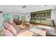 Open living room features lots of natural light, comfortable seating and a built-in display shelving unit at 108 E Walker Dr, Summerville, SC 29483
