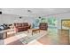 Open living area featuring a projector, exposed floors, and glass doors to outside patio at 108 E Walker Dr, Summerville, SC 29483