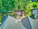A view of the roof and backyard space, complete with a patio, garden area, and mature trees at 1111 Ole South Ct, Moncks Corner, SC 29461