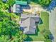 A bird's eye view of a home with a spacious yard, detached garage, and lush tree coverage at 1111 Ole South Ct, Moncks Corner, SC 29461