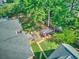 A look at the roof and backyard with patio seating, a lush garden, and mature trees providing shade at 1111 Ole South Ct, Moncks Corner, SC 29461