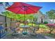 Inviting back patio with a red umbrella, table and chairs for outdoor dining and relaxation at 1111 Ole South Ct, Moncks Corner, SC 29461