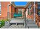 Rear porch with seating and stairs leading to a brick-paved area, offering outdoor relaxation at 1111 Ole South Ct, Moncks Corner, SC 29461
