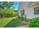 Side yard featuring a well-kept lawn and lush garden at 1111 Ole South Ct, Moncks Corner, SC 29461