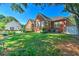 Spacious backyard with brick home, healthy lawn, and meticulous landscaping at 1111 Ole South Ct, Moncks Corner, SC 29461