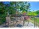 Backyard deck with outdoor seating, a small table, and lush landscaping beyond the railing at 1111 Ole South Ct, Moncks Corner, SC 29461