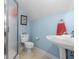 Light blue bathroom featuring a pedestal sink, toilet, and glass-enclosed shower at 1111 Ole South Ct, Moncks Corner, SC 29461