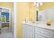 Bright bathroom featuring a white vanity and cabinet with a decorative mirror at 1111 Ole South Ct, Moncks Corner, SC 29461