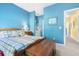 Bedroom with blue walls, a patterned bedspread, wood chest and art on the wall at 1111 Ole South Ct, Moncks Corner, SC 29461