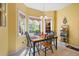 Cozy dining area features a wooden table with seating for four, bathed in natural light from adjacent windows at 1111 Ole South Ct, Moncks Corner, SC 29461