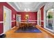 Formal dining area with a wooden table and chairs, complemented by an elegant chandelier and bright natural light at 1111 Ole South Ct, Moncks Corner, SC 29461