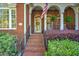 The front entrance of this home features an American flag and brick steps leading to the front door at 1111 Ole South Ct, Moncks Corner, SC 29461