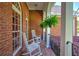 View of the porch, complete with hanging ferns and rocking chairs at 1111 Ole South Ct, Moncks Corner, SC 29461