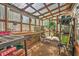 Sunlit greenhouse with potting benches and transparent roof for gardening at 1111 Ole South Ct, Moncks Corner, SC 29461