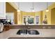 Modern kitchen sink setup bathed in natural light from bay windows overlooking backyard at 1111 Ole South Ct, Moncks Corner, SC 29461