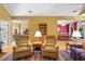 Spacious living room showcases hardwood floors and is flanked by open dining and kitchen spaces at 1111 Ole South Ct, Moncks Corner, SC 29461