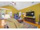 Bright living room with hardwood floors, large TV, comfortable seating, and ample natural light at 1111 Ole South Ct, Moncks Corner, SC 29461