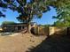 Spacious backyard with a new fence featuring lush grass and a shade tree at 121 Camelot Dr, Goose Creek, SC 29445