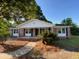 Charming single-story home featuring a well-manicured lawn and inviting front porch at 121 Camelot Dr, Goose Creek, SC 29445