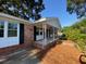 Side angle view of the covered front porch of this single story brick home at 121 Camelot Dr, Goose Creek, SC 29445