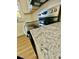 Close-up of a granite countertop of a modern kitchen appliance with white cabinets at 121 Camelot Dr, Goose Creek, SC 29445