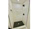 A modern walk-in shower features black honeycomb tile and white subway tile at 121 Camelot Dr, Goose Creek, SC 29445