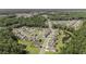 A panoramic aerial shot showcases a residential community with lush green spaces, ponds, and well-maintained homes at 121 Cherry Grove, Summerville, SC 29483