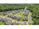 An aerial view of a neighborhood featuring well-maintained homes and a central community park and surrounding green areas at 121 Cherry Grove, Summerville, SC 29483