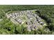 An aerial view of a suburban neighborhood with winding streets, modern homes, green spaces, and a playground at 121 Cherry Grove, Summerville, SC 29483