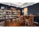 Cozy bar area with hardwood floors, custom shelving, and comfortable seating for entertaining guests at 121 Cherry Grove, Summerville, SC 29483