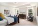 Spacious bedroom with a large bed, dresser, and seating area, filled with natural light from the windows at 121 Cherry Grove, Summerville, SC 29483