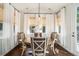 Bright dining room features a round wooden table, elegant chairs, and sheer curtains at 121 Cherry Grove, Summerville, SC 29483