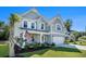 Beautiful two-story home featuring a stone facade, inviting porch, and meticulously landscaped front yard at 121 Cherry Grove, Summerville, SC 29483