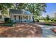 A charming cottage with a covered porch, rocking chairs, and a welcoming exterior exudes cozy comfort in a natural setting at 121 Cherry Grove, Summerville, SC 29483