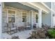 Inviting front porch featuring stone accents, rocking chairs, and a welcoming wreath on the door at 121 Cherry Grove, Summerville, SC 29483