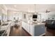 Open concept kitchen features an island with seating flowing into a dining area and living space with a fireplace at 121 Cherry Grove, Summerville, SC 29483