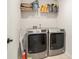 Clean laundry room with modern washer and dryer, storage shelf, and bright lighting for convenience at 121 Cherry Grove, Summerville, SC 29483