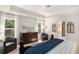Elegant primary bedroom featuring a dresser, sitting chairs, bright windows, and an ensuite bathroom at 121 Cherry Grove, Summerville, SC 29483