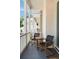 Balcony with chairs overlooks the neighborhood architecture at 122 Beaufain St # C, Charleston, SC 29401