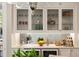 Wet bar featuring wine coolers, sink, counter seating with stylish display cabinets at 122 Beaufain St # C, Charleston, SC 29401