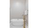 Elegant bathroom featuring a freestanding tub with gold fixtures and white marble tile flooring at 122 Beaufain St # C, Charleston, SC 29401