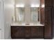 Double sink bathroom vanity featuring a marble countertop, and dark stained wood cabinets at 122 Beaufain St # C, Charleston, SC 29401