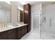Bathroom showcasing a glass enclosed shower with gold fixtures and a dark stained vanity at 122 Beaufain St # C, Charleston, SC 29401