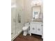 Stylish bathroom featuring a glass shower, dark floors, toilet, vanity, and elegant gold fixtures at 122 Beaufain St # C, Charleston, SC 29401